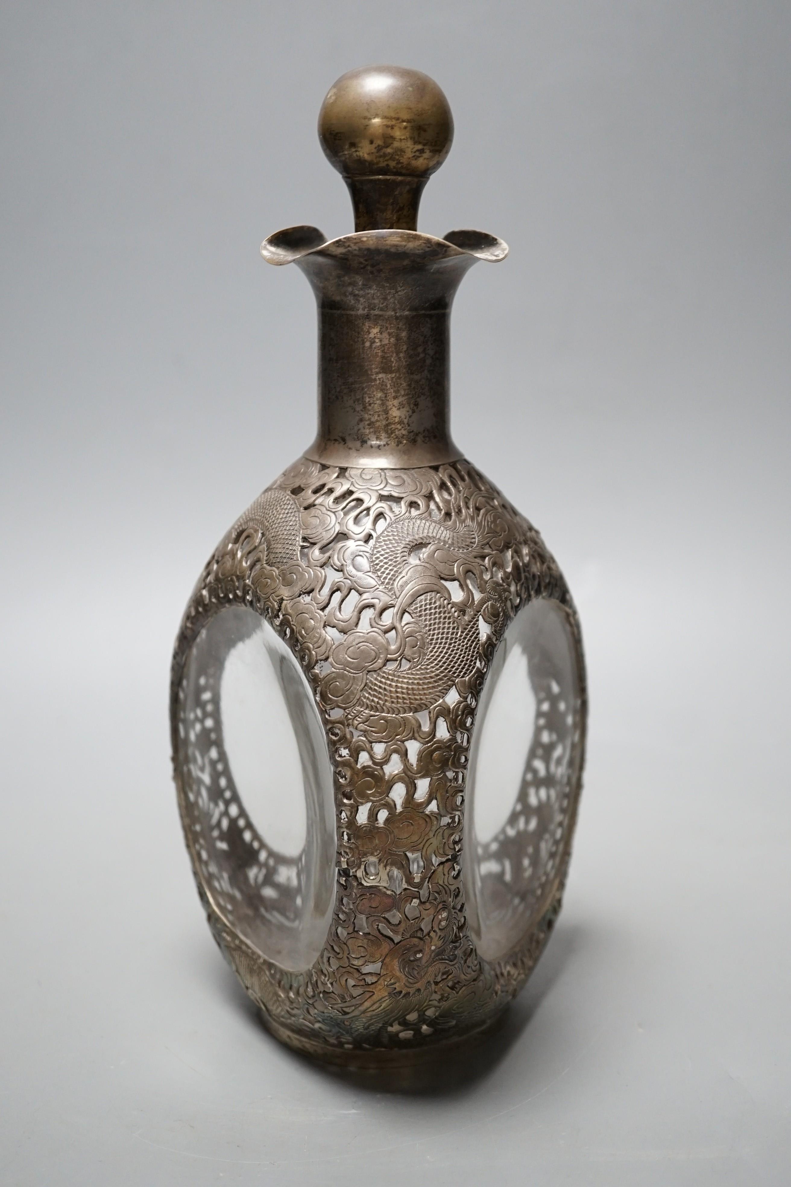 A Chinese white metal mounted glass 'dimple' decanter and stopper, by Wang Hing, Hong Kong, 26.5cm.